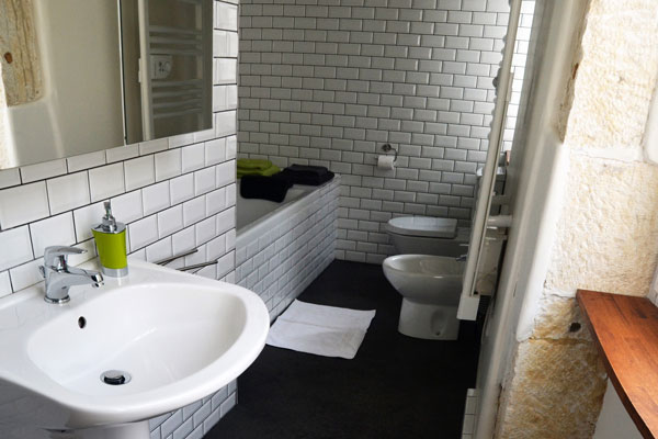 bathroom with bath in room Mauzac at Le Manoir