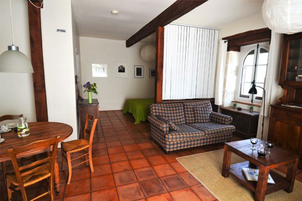 sitting and dining area and kitchen of gite manseng Le Manoir Souillac